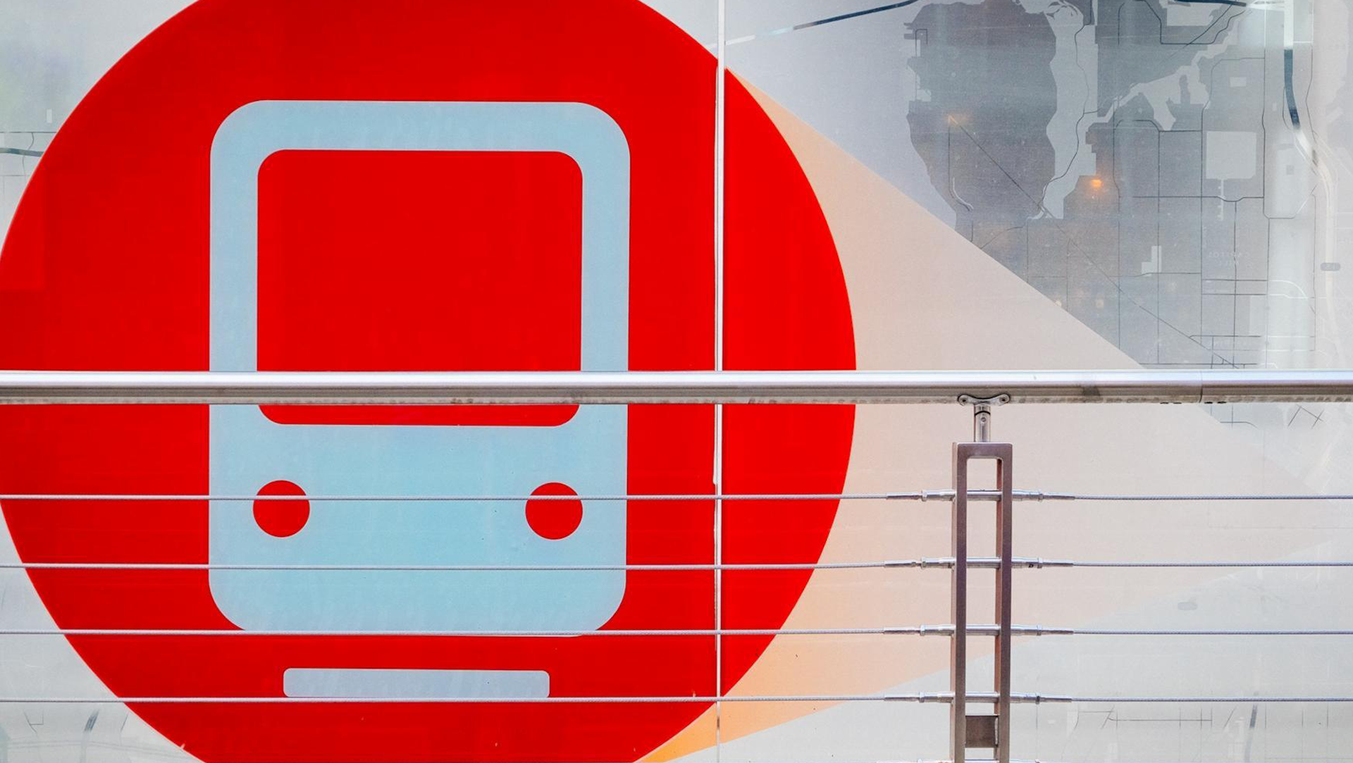 Universal sign for a train against a bright red background