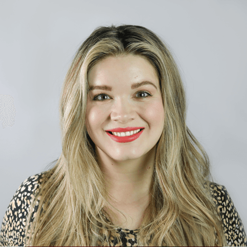 Chloe smiles at the camera. She is wearing red lipstick. Chloe smiles at the camera. She is wearing red lipstick.