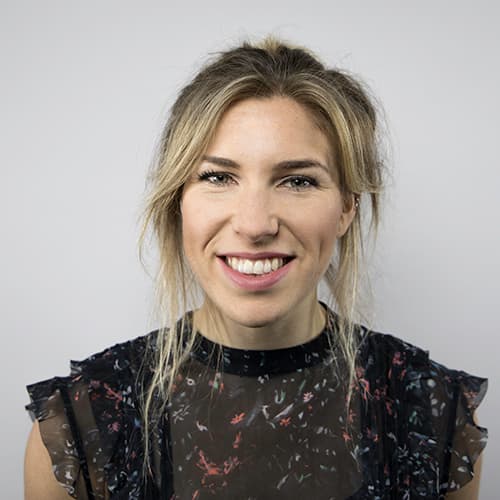 Hannah is smiling at the camera. She is wearing a black top. Hannah is smiling at the camera. She is wearing a black top.