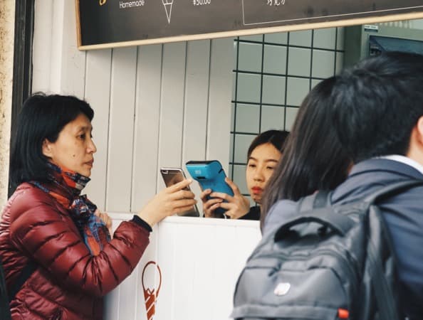 QR codes being scanned on mobile by a payments device QR codes being scanned on mobile by a payments device