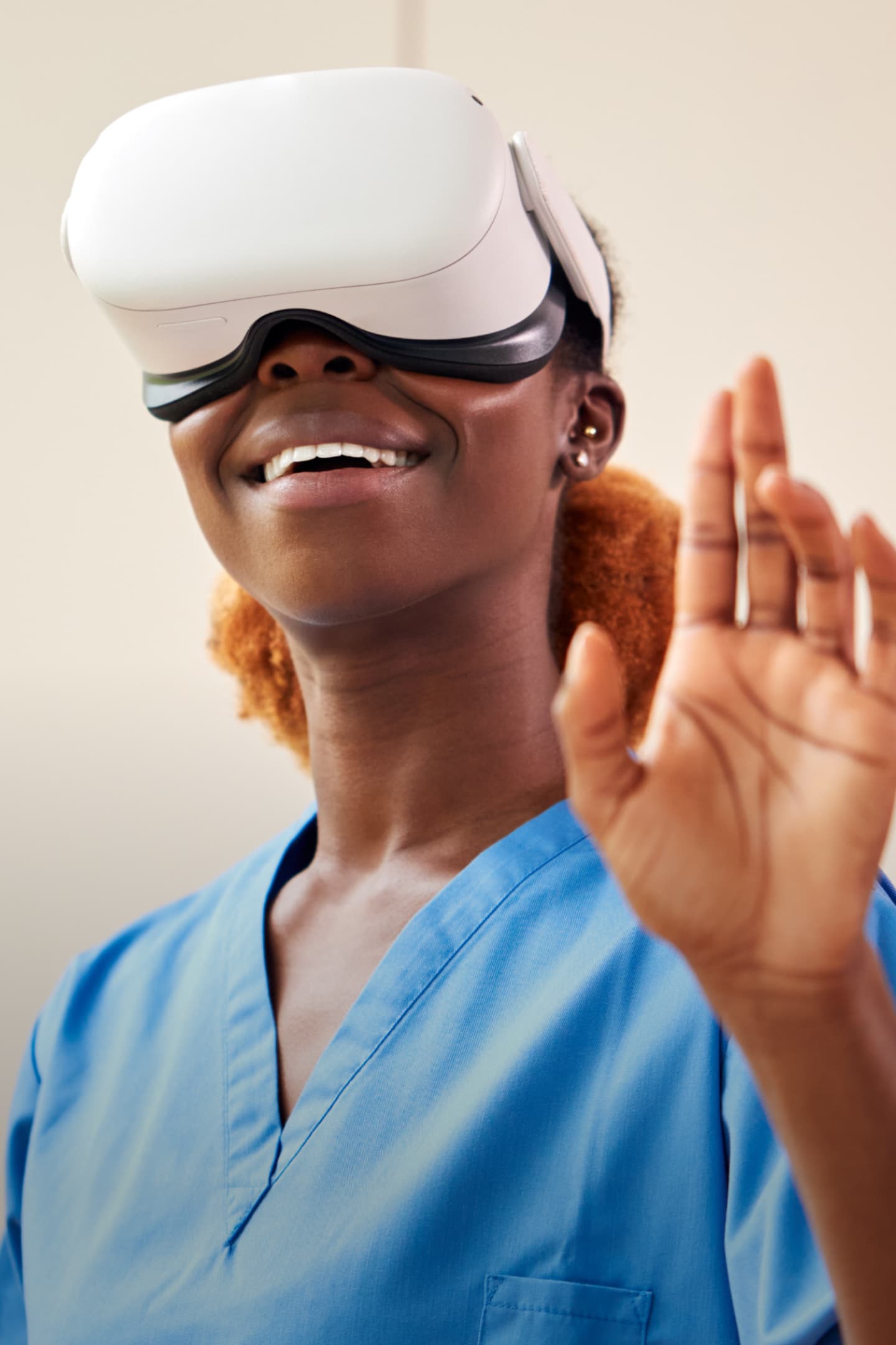Photo of a nurse smiling using a VR headset Photo of a nurse smiling using a VR headset