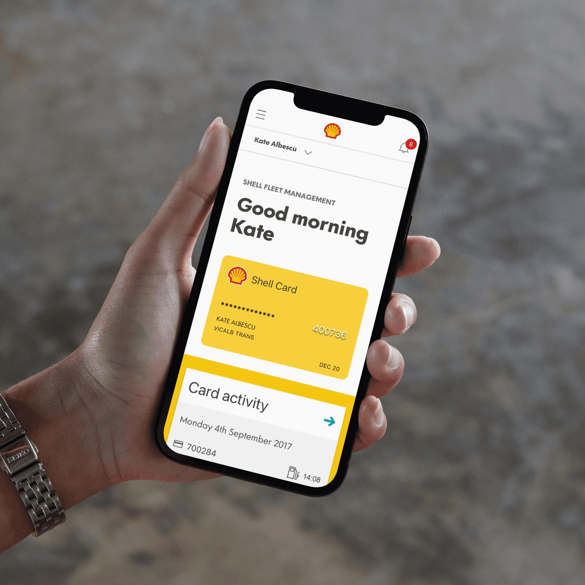 Someone holds a phone, which has the shell fleet hub app on its screen. Someone holds a phone, which has the shell fleet hub app on its screen.
