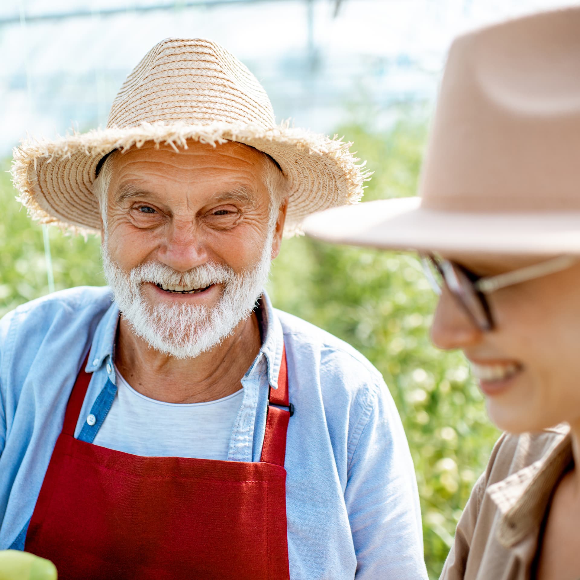 A man in straw hat smiling A man in straw hat smiling